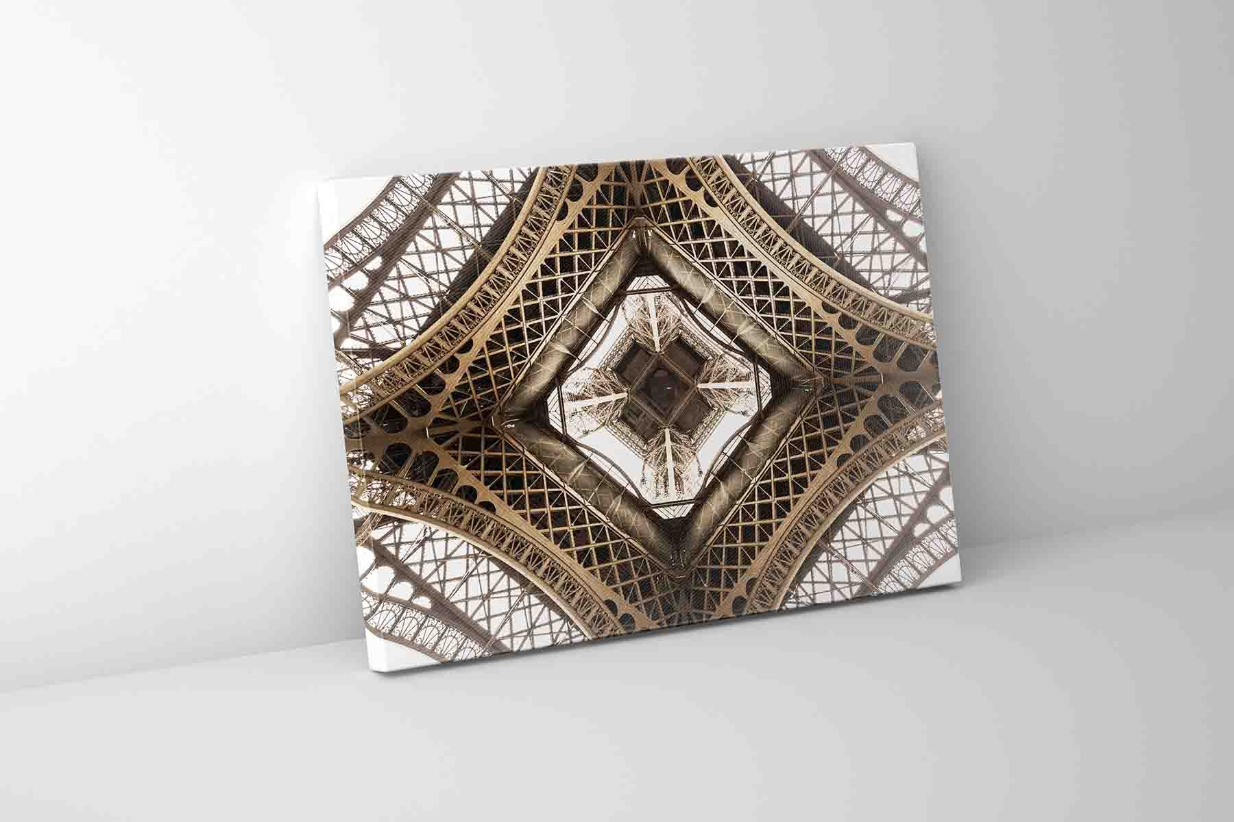 A canvas print featuring a close-up geometric pattern of the Eiffel Tower's structure.
